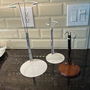 THREE doll stands of different sizes for displaying dolls
